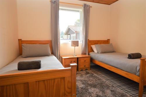 Tempat tidur dalam kamar di Deer Croft Lodge