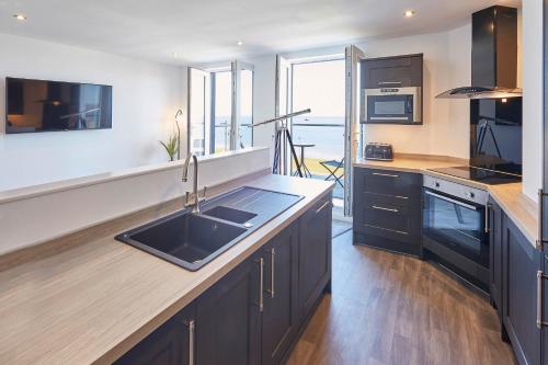 a kitchen with a sink and a counter top at Host & Stay - The Waves in Whitby