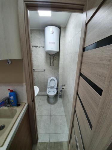 a small bathroom with a toilet and a sink at Light room Затока in Zatoka