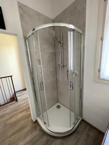 a shower with a glass enclosure in a room at Green Rooms Ferrara in Ferrara