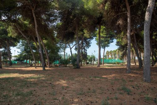 a park with a lot of trees and grass at Tursport in Taranto