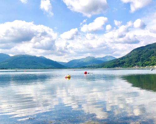 a large body of water with mountains in the background at Deer Croft Lodge in Hunters Quay