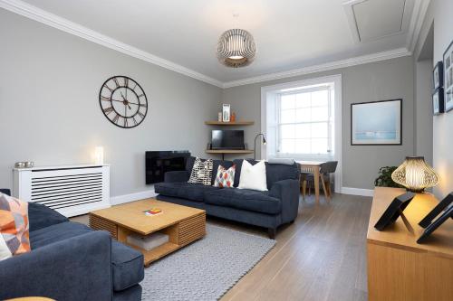 a living room with a couch and a table at JOIVY Splendid Apartment in New Town in Edinburgh
