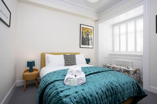 a bedroom with a bed with two masks on it at JOIVY Splendid Apartment in New Town in Edinburgh