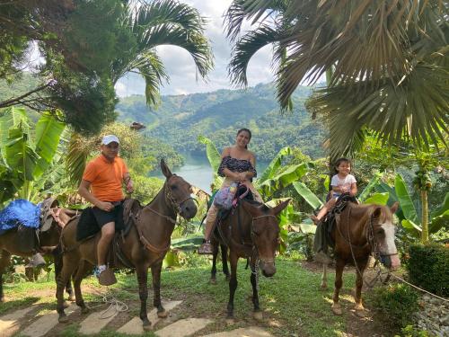 a group of people riding horses with a woman and a child at Ecohotel Campo Alegre Norcasia Caldas in Norcasia