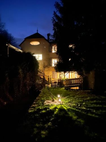 a house at night with a light in the grass at Domaine Du Moulin Vallée Heureuse in Poligny