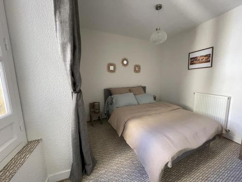 une chambre avec un lit dans le coin d'une pièce dans l'établissement « Le traversin » Centre Sarlat App. 2 chambres, à Sarlat-la-Canéda