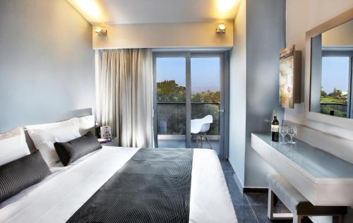 a hotel room with a large bed and a window at Anna's House in Georgioupolis