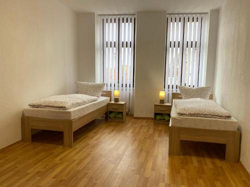 a room with two beds and two candles in it at Ferienwohnung H&M Immobilien Alsleben 2 in Alsleben