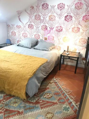 a bedroom with a bed and a side table at Villa sainte claire in Amélie-les-Bains-Palalda