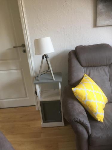 a lamp sitting on a table next to a couch at Ferienwohnanlage Sturmhöhe in Welt