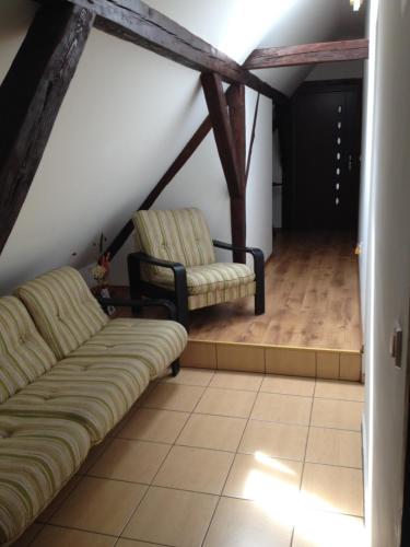 a living room with two chairs and a couch at Casa Maria in Şura Mică