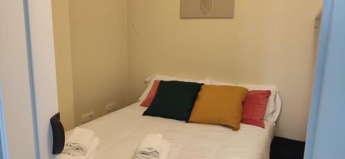 - un lit avec 4 oreillers colorés dans l'établissement INSIDEHOME Apartments - El Capricho de Elsa, à Unquera