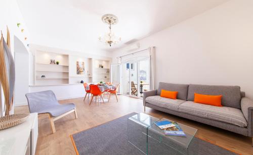 a living room with a couch and a table at Casa Feliz in Lagos in Lagos