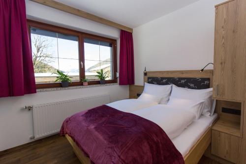 a bedroom with a large bed and a window at Reinthalers in Werfenweng