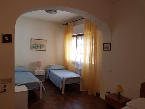 a room with two beds and an arched window at Villa Ania in Mondello