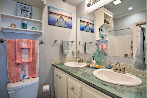 a bathroom with two sinks and a toilet and a mirror at Pet-Friendly Lakefront Getaway with Hot Tub! in Coffee City