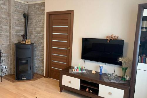 a living room with a flat screen tv on a wall at Skolas street seaside space! in Jūrmala