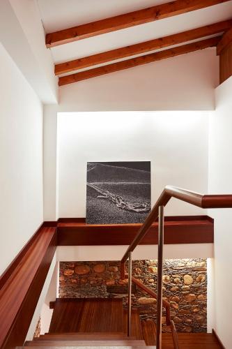 a staircase in a house with a stone fireplace at Casa da Pedra Rolada in Janeiro de Cima