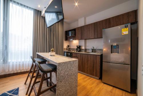 a kitchen with a counter and a refrigerator at Cali River Suites by Yellowkey Capital in Cali