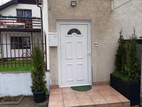 a white door on the side of a house at Apartman MITIĆ in Požarevac