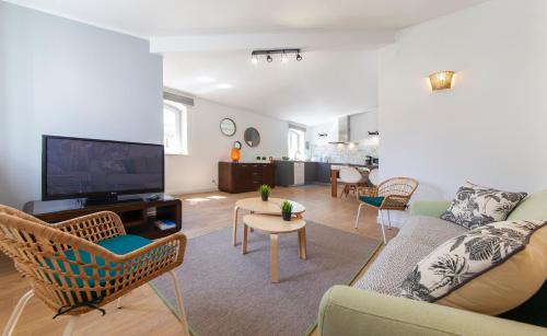 a living room with a couch and a tv at Casa Feliz in Lagos in Lagos