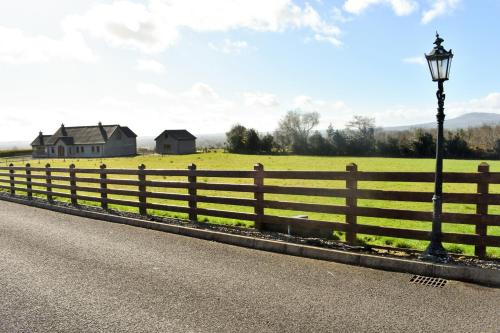 a fence and a street light on the side of a road at Glenshane Country House in Maghera