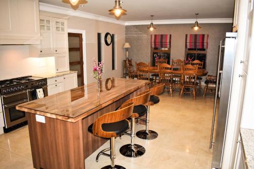 a kitchen with a large island with bar stools at Glenshane Country House in Maghera