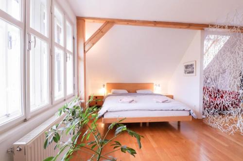 a bedroom with a bed in a room with windows at Apartment in the heart of Bled with views in Bled