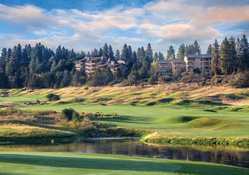 a golf course with a river and houses on a hill at WorldMark Running Y in Klamath Falls
