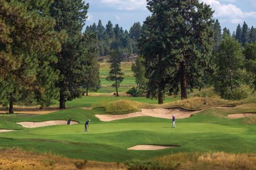 a group of people playing golf on a golf course at WorldMark Running Y in Klamath Falls