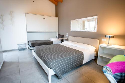 a small bedroom with a bed and a chair at Magrine Castelfranco Veneto in Castelfranco Veneto