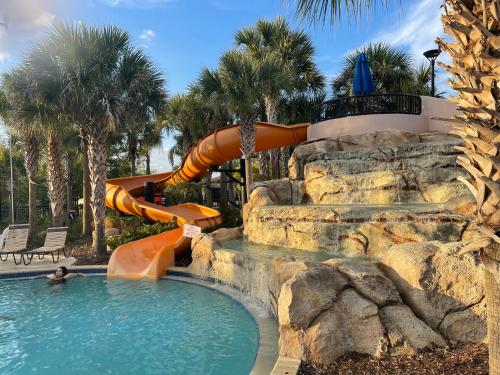 a pool with a water slide in a resort at Havilah Vacation Villas Resort Club in Davenport