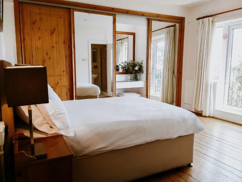 a bedroom with a large bed and a large mirror at The Sands B&B Rostrevor in Rostrevor