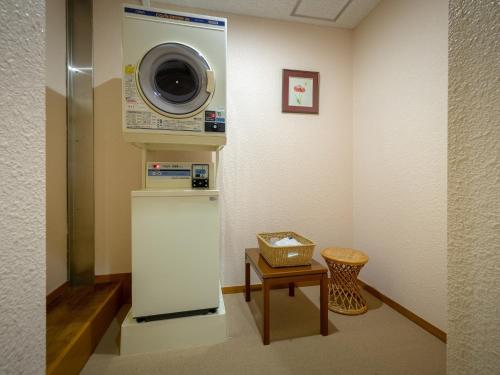 a laundry room with a washing machine and a table at Lake View Inaedaiso - Vacation STAY 34438v in Inawashiro