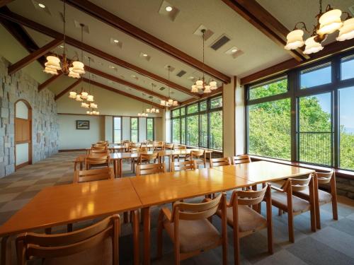 a large room with tables and chairs and large windows at Lake View Inaedaiso - Vacation STAY 34438v in Inawashiro