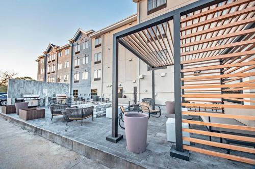 a patio with tables and chairs in front of a building at Staybridge Suites - Cedar Rapids North by IHG in Cedar Rapids
