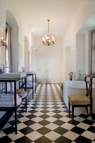 a bathroom with a black and white checkered floor at Schloss Freudenstein in Appiano sulla Strada del Vino