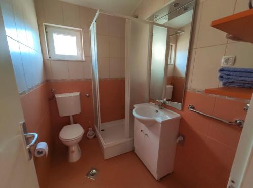 a bathroom with a toilet and a sink and a shower at Apartments Karla in Rogoznica