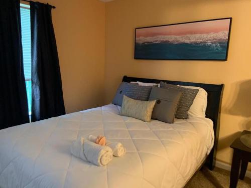 a bed with a stuffed animal on top of it at #Cozy2BR Near Stonecrest Stone MTN Park in Lithonia