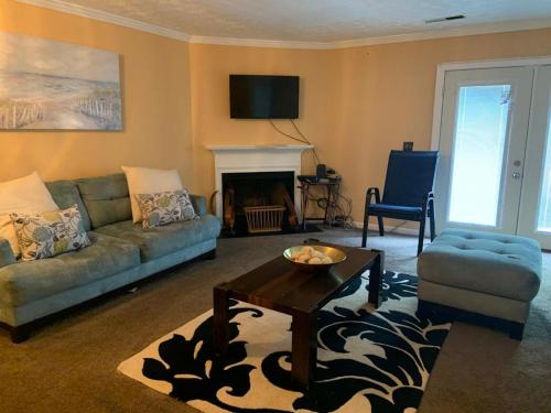 a living room with a couch and a table at #Cozy2BrVilla in Lintonia - NearStone MTN Park in Lithonia