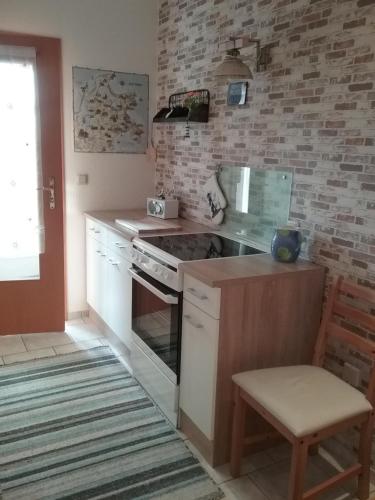 a kitchen with a stove and a counter top at Ferienwohnung Paula, Kluis in Gagern