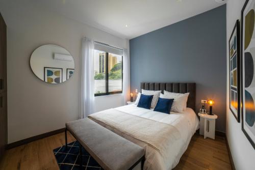 a bedroom with a large bed and a window at Cali River Suites by Yellowkey Capital in Cali