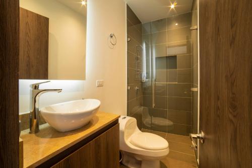 a bathroom with a sink and a toilet and a shower at Cali River Suites by Yellowkey Capital in Cali