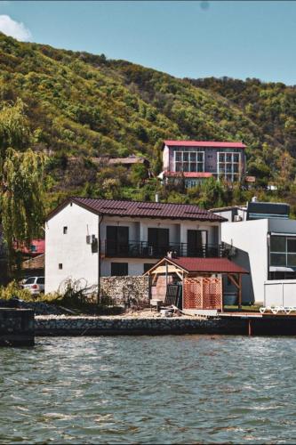 a house on a hill next to the water at Escape in Dubova
