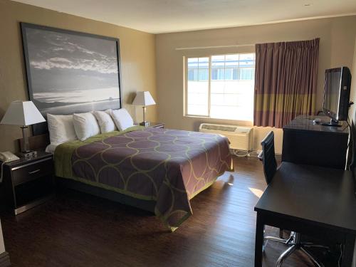a hotel room with a bed and a window at Skyways Hotel in Los Angeles