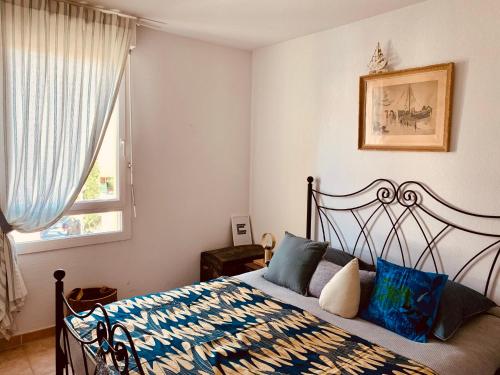 een slaapkamer met een bed en een raam bij Le Saint Loup (terrasse et parking) in La Ciotat