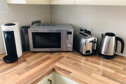 a microwave sitting on top of a kitchen counter at Modern House in Bournemouth town centre in Bournemouth