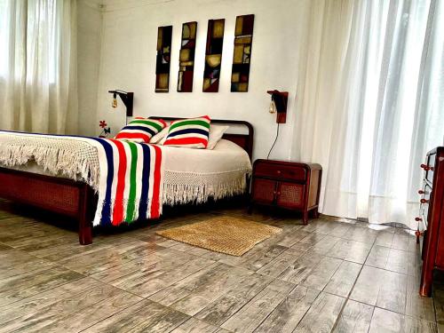 Un dormitorio con una cama con almohadas de colores. en Cabaña Encanto de Luna, en San Francisco