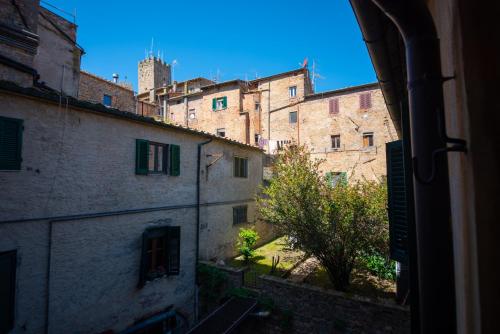 a view from a window of an alley with buildings at Il Giardino Segreto B&B in Volterra